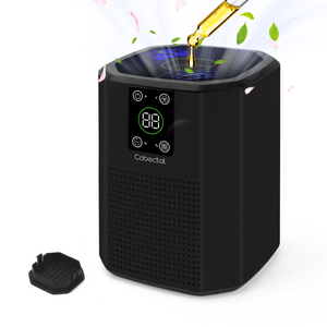 Cobectal ZQ2000C air purifier , sleek black design with digital display. Shown with essential oil being added, releasing fragrance. Includes all components for aromatherapy and purification.