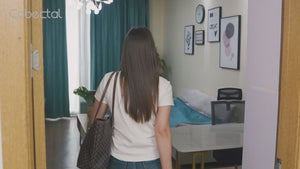 Cobectal air purifier (black) in action: video captures a woman interacting with its user-friendly touch-sensitive control panel, where the digital display shows "FI" alongside the tagline "Every breath is a masterpiece." Upward blue streams and green leaves visualize fresh air flow, highlighting its compact, modern design. The clip emphasizes both real-life usability and core functions—ideal for home and office use, blending practicality with a focus on clean, quality air.